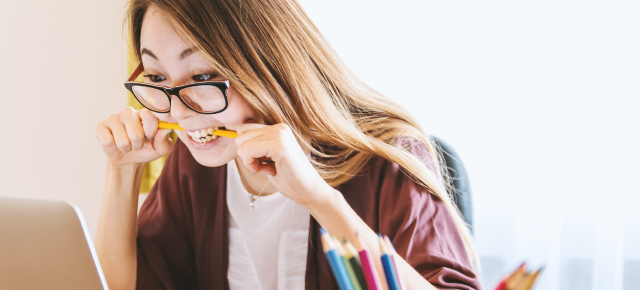 Student biting a pencil. Photo: Unsplash.